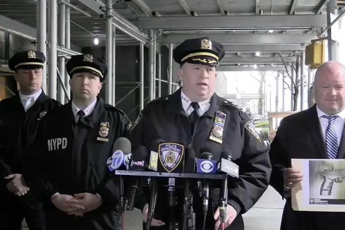 A photograph of NYPD officers briefing reporters after a March 14th shooting on the Upper West Side.